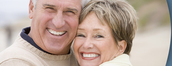 mature man and woman smiling and hugging