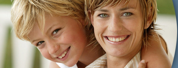 woman and young boy smiling and hugging